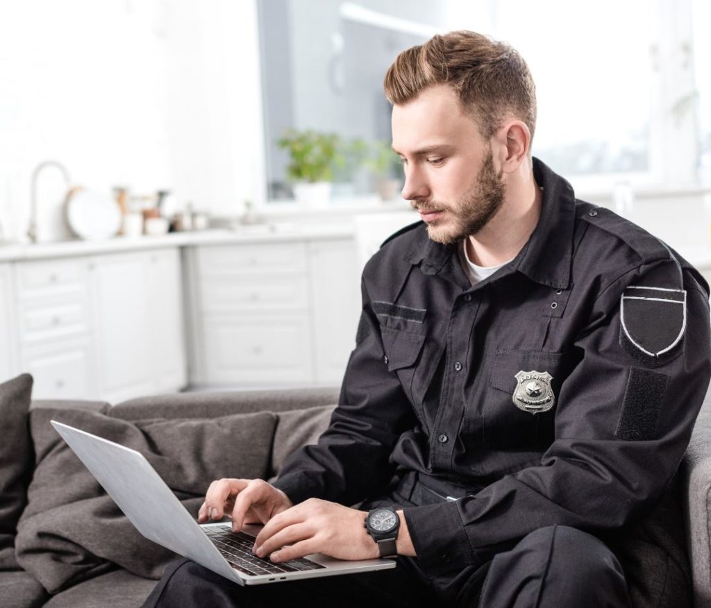 What technology has affected the criminal justice system. Officer on laptop